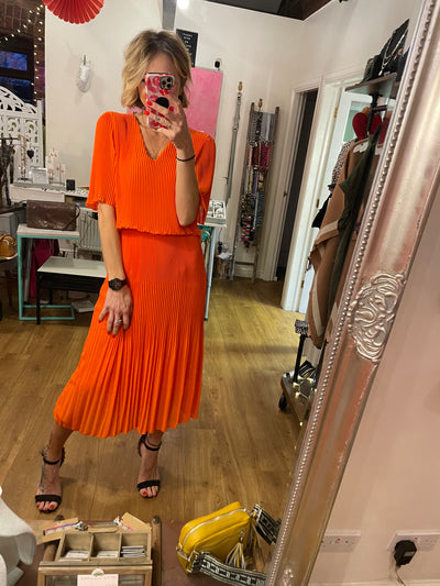 PLEATED DRESS IN ORANGE -  The Style Society Boutique 